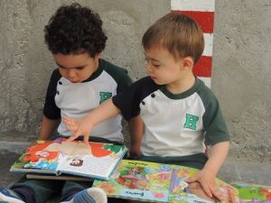 Alumnos de Nursery disfrutan en el patio viendo cuentos. 