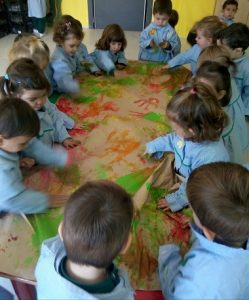 Los alumnos de Nursery 2 realizan el mural del otoño. 